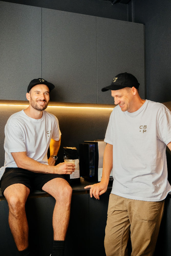 Two men in the office drinking wholesale coffee