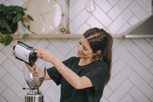 woman pouring coffee beans